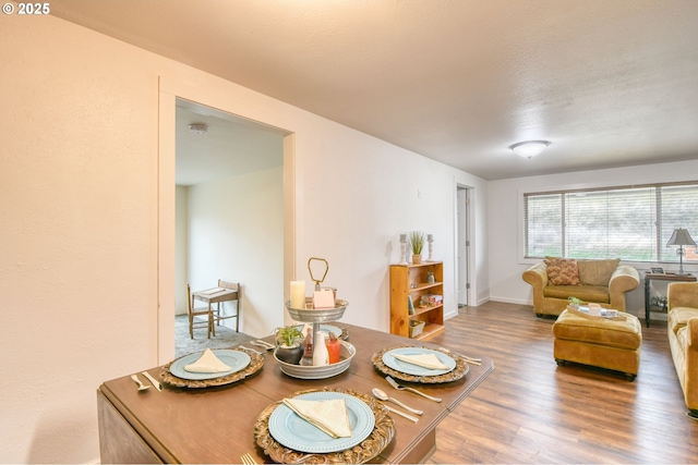 living room featuring wood finished floors and baseboards