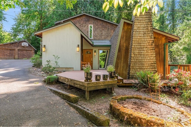 3820 Kenthorpe Way W, Linn, OR 97068 - view of front of property with an outdoor structure, a wooden deck, a detached garage, and a chimney