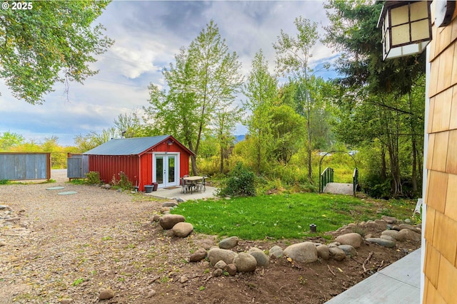 37459 Boulder Flat Ln, Halfway, OR 97834 - view of green lawn featuring french doors, an outdoor structure, and a patio