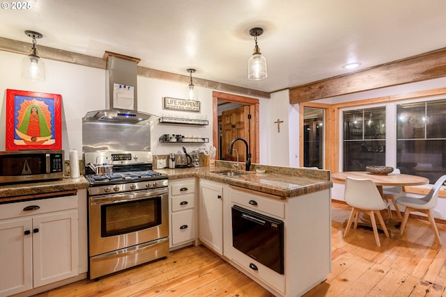 37459 Boulder Flat Ln, Halfway, OR 97834 - kitchen featuring stainless steel appliances, a peninsula, a sink, light wood-type flooring, and wall chimney range hood