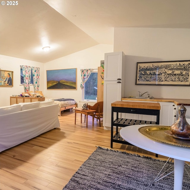 37459 Boulder Flat Ln, Halfway, OR 97834 - bedroom with vaulted ceiling, light wood-style flooring, and wet bar