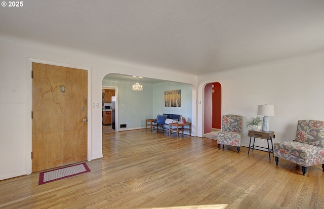 sitting room featuring light hardwood / wood-style floors and a notable chandelier