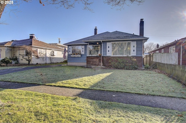 bungalow-style house with a front yard