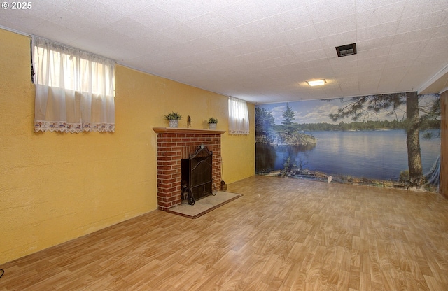 living room featuring hardwood / wood-style flooring and a brick fireplace