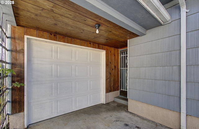 garage featuring wood walls