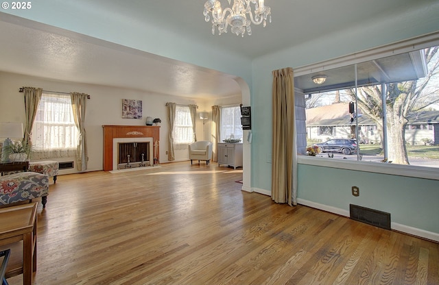 living room with hardwood / wood-style floors and a notable chandelier