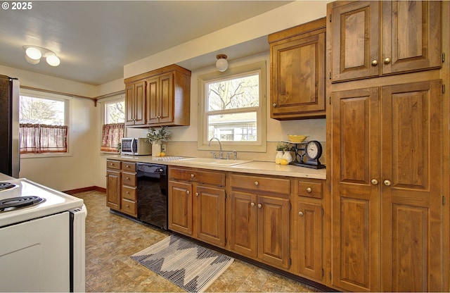 kitchen with stainless steel refrigerator, white range with electric cooktop, dishwasher, and sink