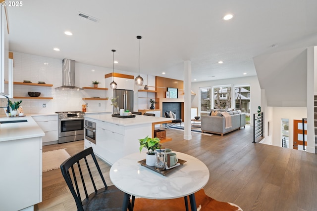dining area featuring visible vents, light wood-type flooring, and recessed lighting