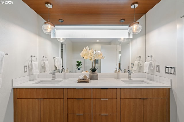 bathroom featuring a sink and double vanity