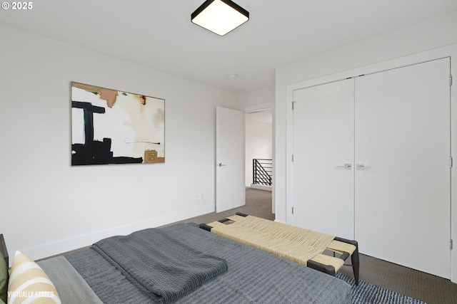 bedroom with a closet, baseboards, and carpet