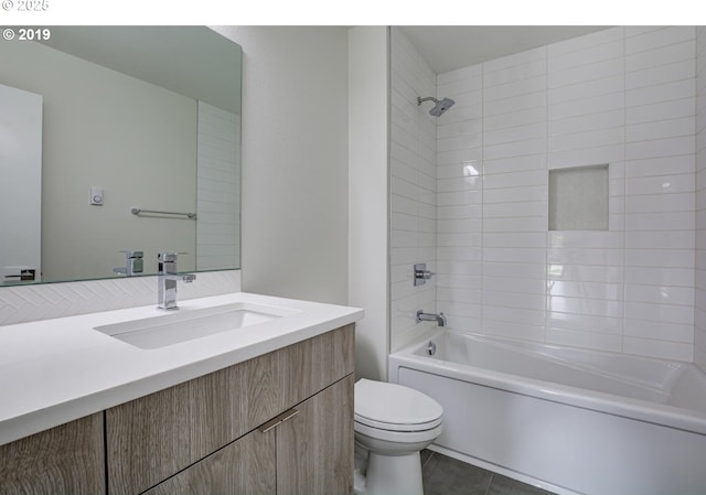 bathroom with tile patterned flooring, toilet, shower / bathing tub combination, and vanity