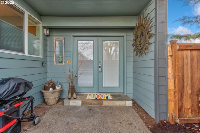 property entrance with french doors and fence