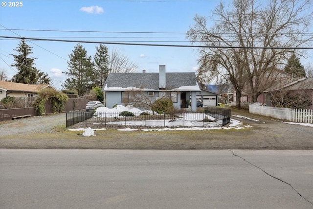 view of front of house featuring a fenced front yard and a chimney