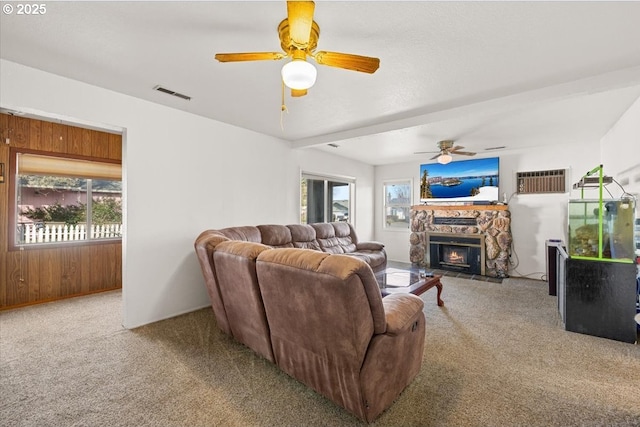 1711 Prune St, Medford, OR 97501 - living room featuring carpet floors, visible vents, a ceiling fan, and a stone fireplace