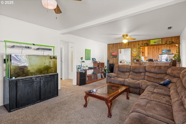 1711 Prune St, Medford, OR 97501 - carpeted living area featuring wood walls, visible vents, a ceiling fan, and beam ceiling