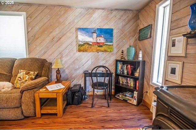 living area with wood walls and wood finished floors