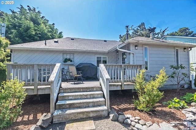 rear view of property featuring stairway and a wooden deck