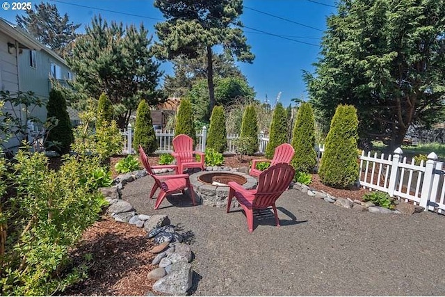 view of yard featuring a fire pit and fence