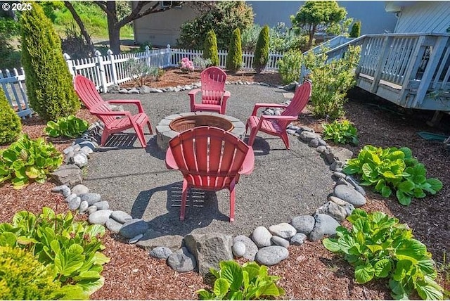 view of patio with a fire pit and fence