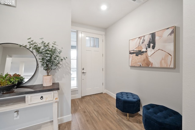 foyer entrance featuring baseboards and light wood-type flooring