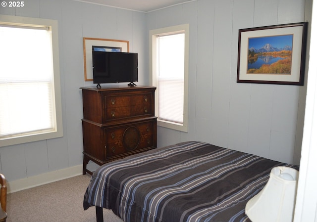 bedroom featuring carpet and a decorative wall