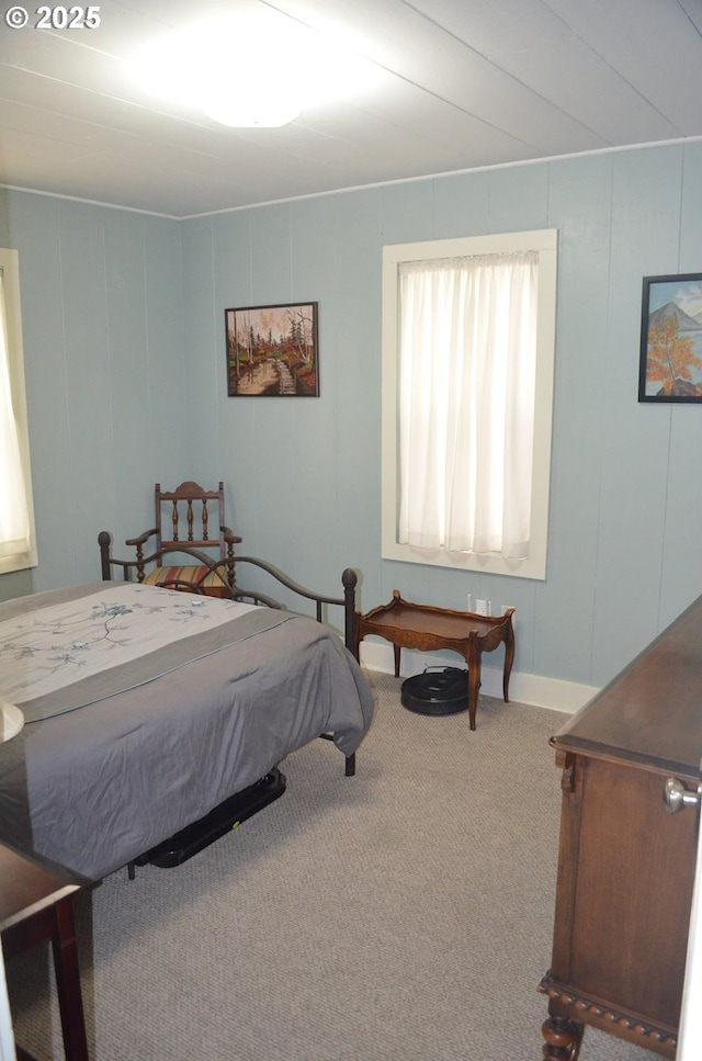 carpeted bedroom featuring a decorative wall