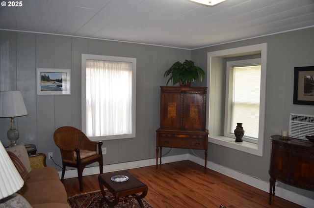 138118 Hillcrest St, Gilchrist, OR 97737 - living room featuring wood finished floors, healthy amount of natural light, a decorative wall, and baseboards