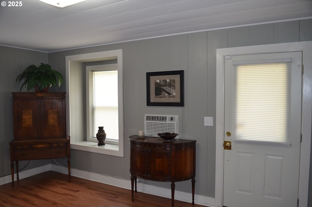 doorway to outside with wood finished floors and baseboards