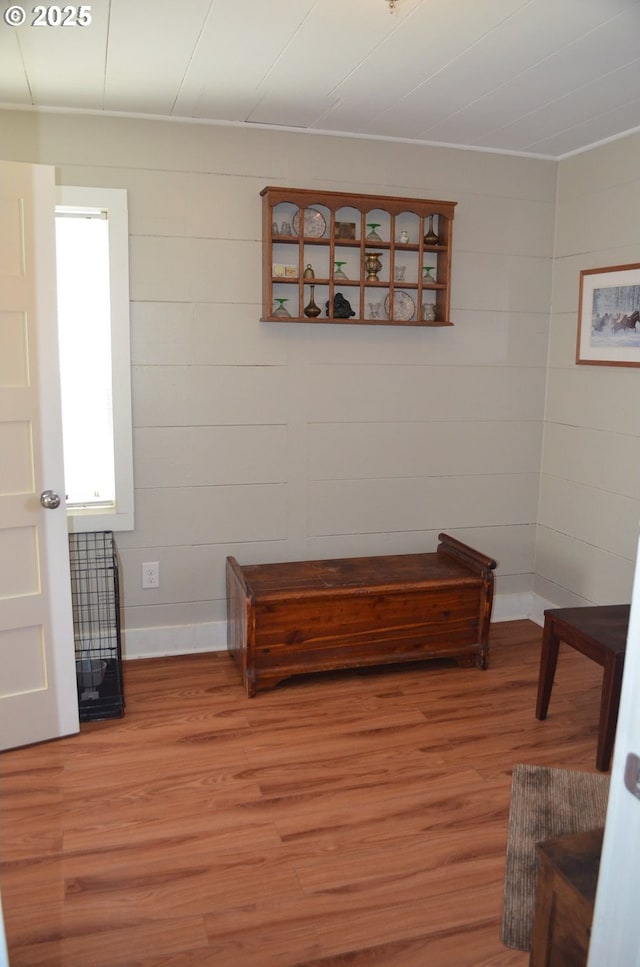 corridor with light wood finished floors and baseboards