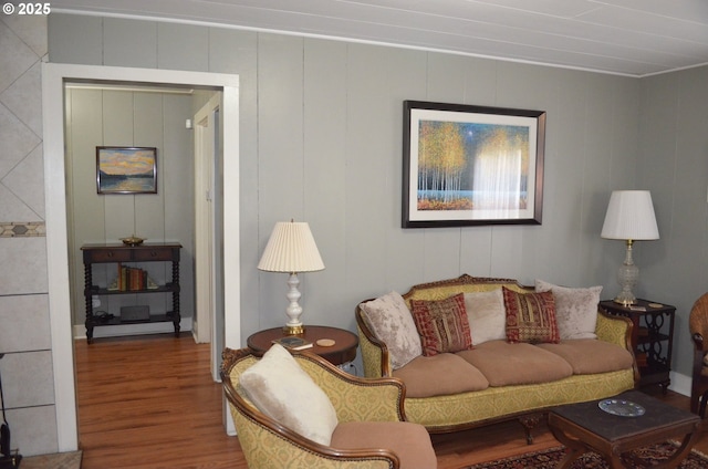 living room featuring wood finished floors and a decorative wall