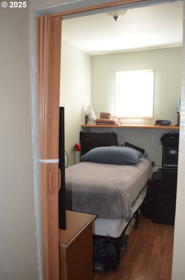 bedroom featuring wood finished floors