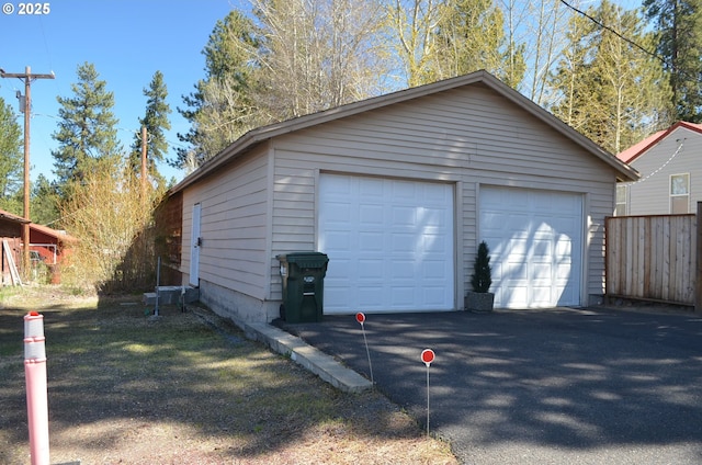 detached garage featuring fence