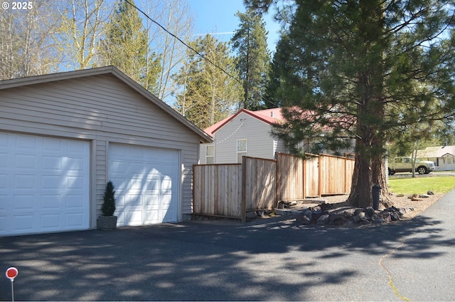 detached garage featuring fence