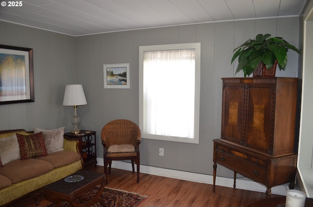 living area with wood finished floors and baseboards