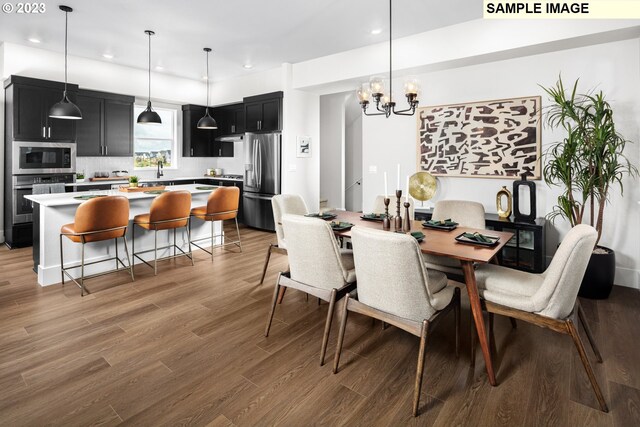 dining room with dark hardwood / wood-style floors and a notable chandelier