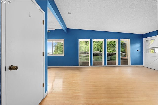 404 Chinook Ave, Astoria, OR 97103 - unfurnished room with a textured ceiling, wood finished floors, baseboards, and beamed ceiling