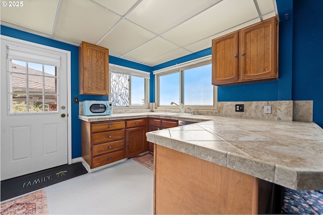 404 Chinook Ave, Astoria, OR 97103 - kitchen featuring a sink, brown cabinets, plenty of natural light, and a peninsula