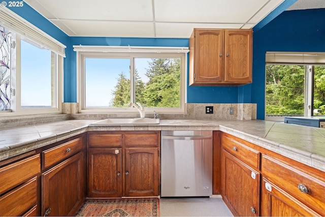 404 Chinook Ave, Astoria, OR 97103 - kitchen with stainless steel dishwasher, a sink, and brown cabinets