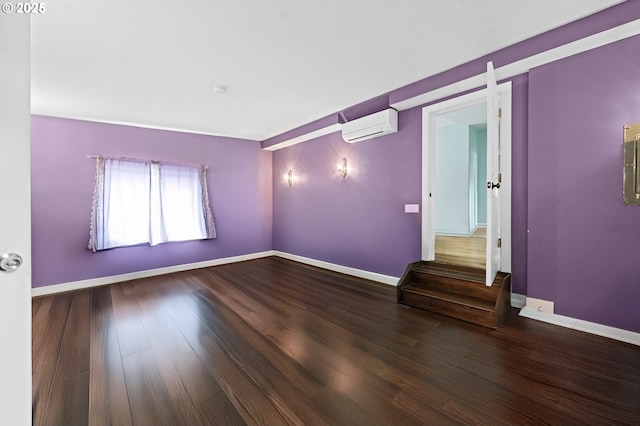 404 Chinook Ave, Astoria, OR 97103 - empty room featuring a wall mounted air conditioner, baseboards, and wood finished floors