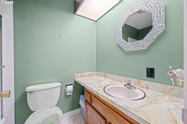 404 Chinook Ave, Astoria, OR 97103 - bathroom with vanity, toilet, baseboards, and tile patterned flooring