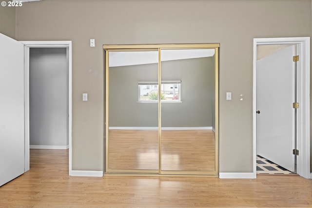 404 Chinook Ave, Astoria, OR 97103 - unfurnished bedroom featuring wood finished floors, a closet, and baseboards