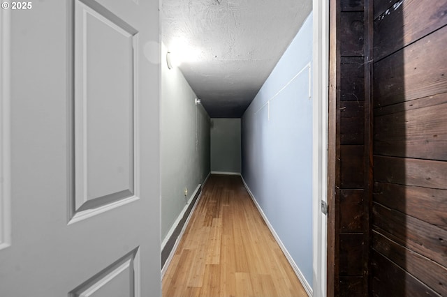 404 Chinook Ave, Astoria, OR 97103 - hallway featuring light wood-style floors, baseboards, and a textured ceiling