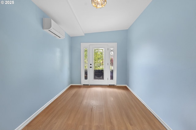 404 Chinook Ave, Astoria, OR 97103 - entryway with an AC wall unit, baseboards, and wood finished floors