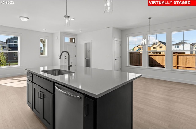 3430 SE 83rd Ave, Hillsboro, OR 97123 - kitchen featuring a sink, dishwasher, light wood finished floors, decorative light fixtures, and baseboards