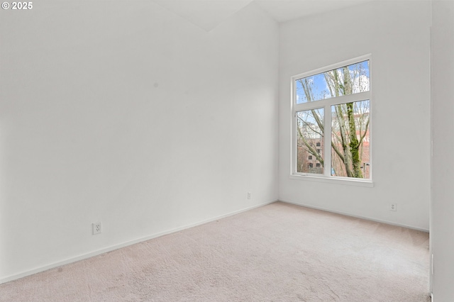 spare room featuring carpet and baseboards