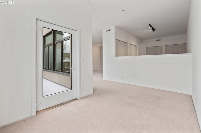 spare room with baseboards and carpet floors