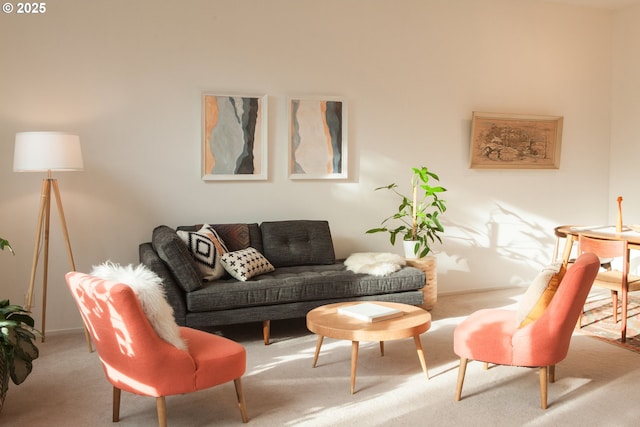 carpeted living area with baseboards