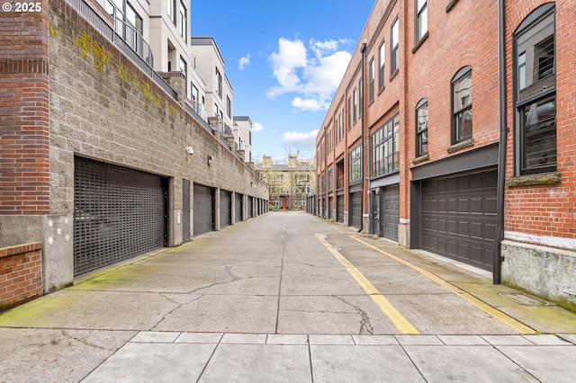 view of road featuring community garages