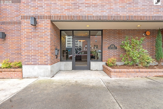 property entrance featuring brick siding