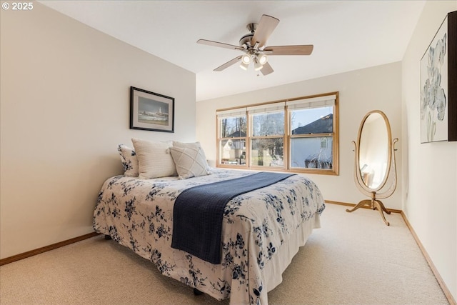 bedroom with ceiling fan and light carpet